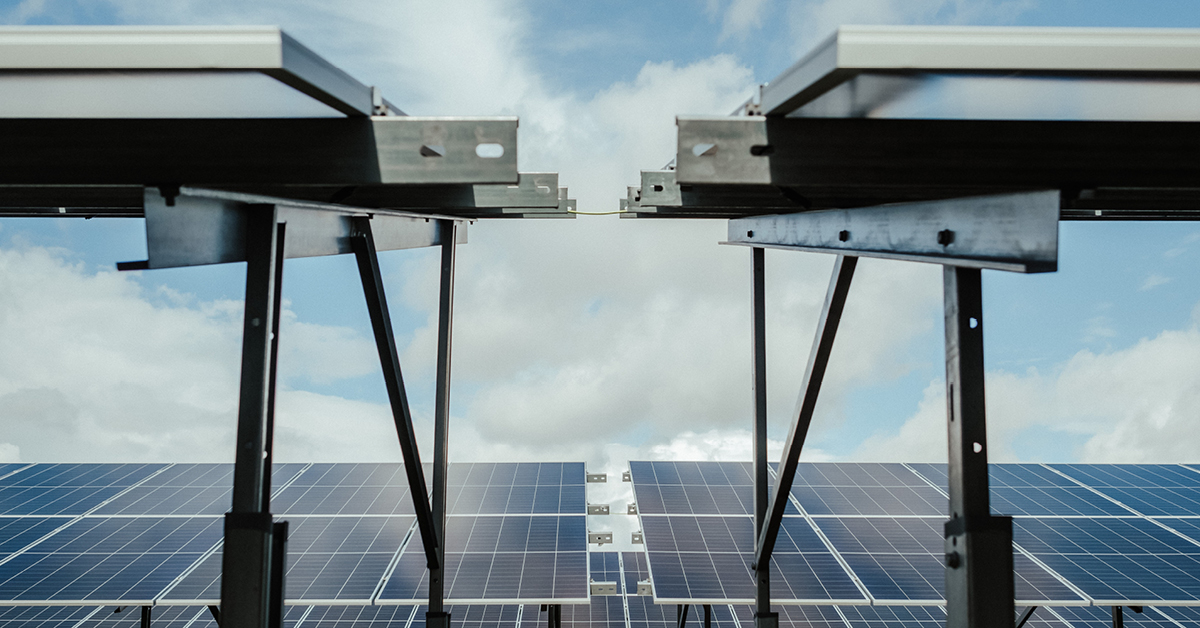 An image of solar panels with the sky in the background.